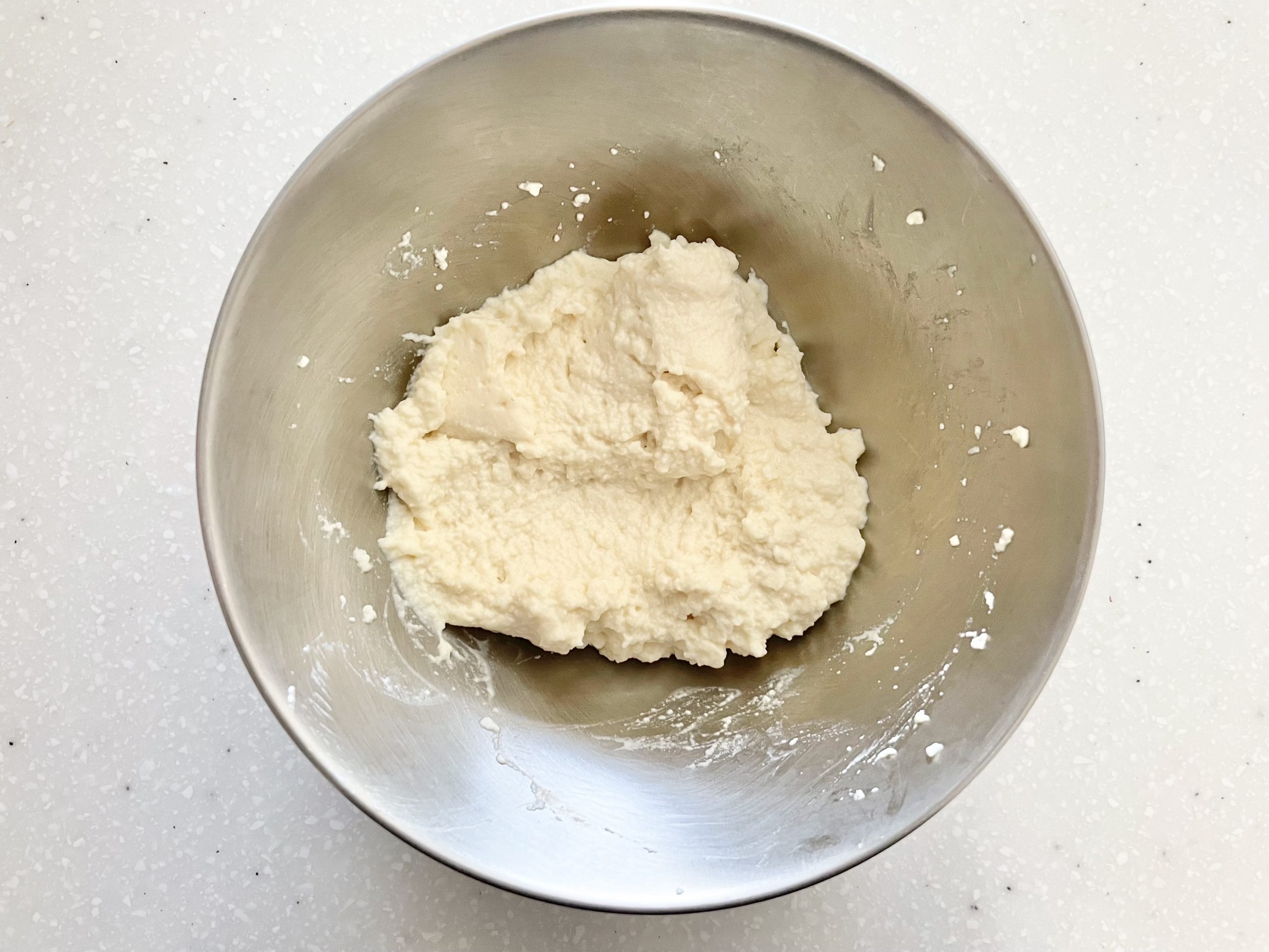 水切りした絹ごし豆腐を、ゴムベラを使ってなめらかになるまでまぜる。※多少粒が残っていても問題ありません