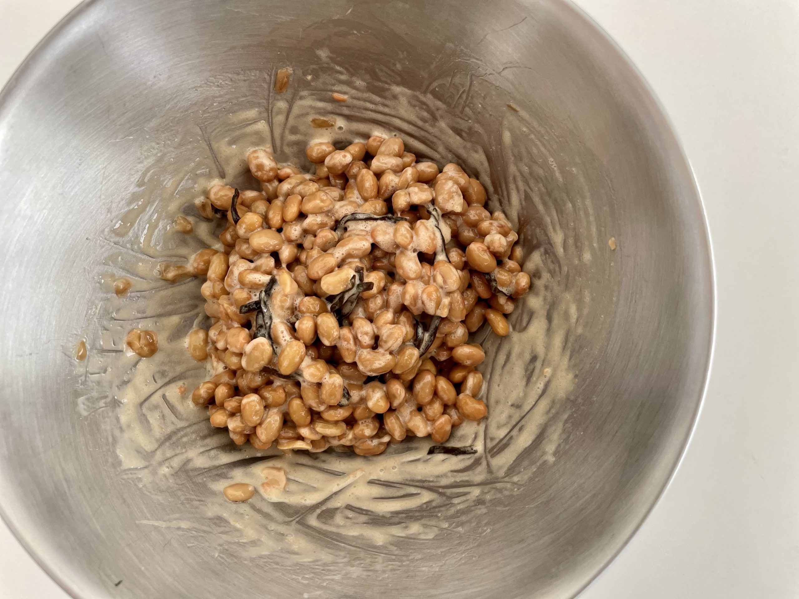 納豆をボウルに移し、粘り気が出るまで混ぜる。<br />
そこへ塩昆布と醤油を入れて更に混ぜる。<br />

