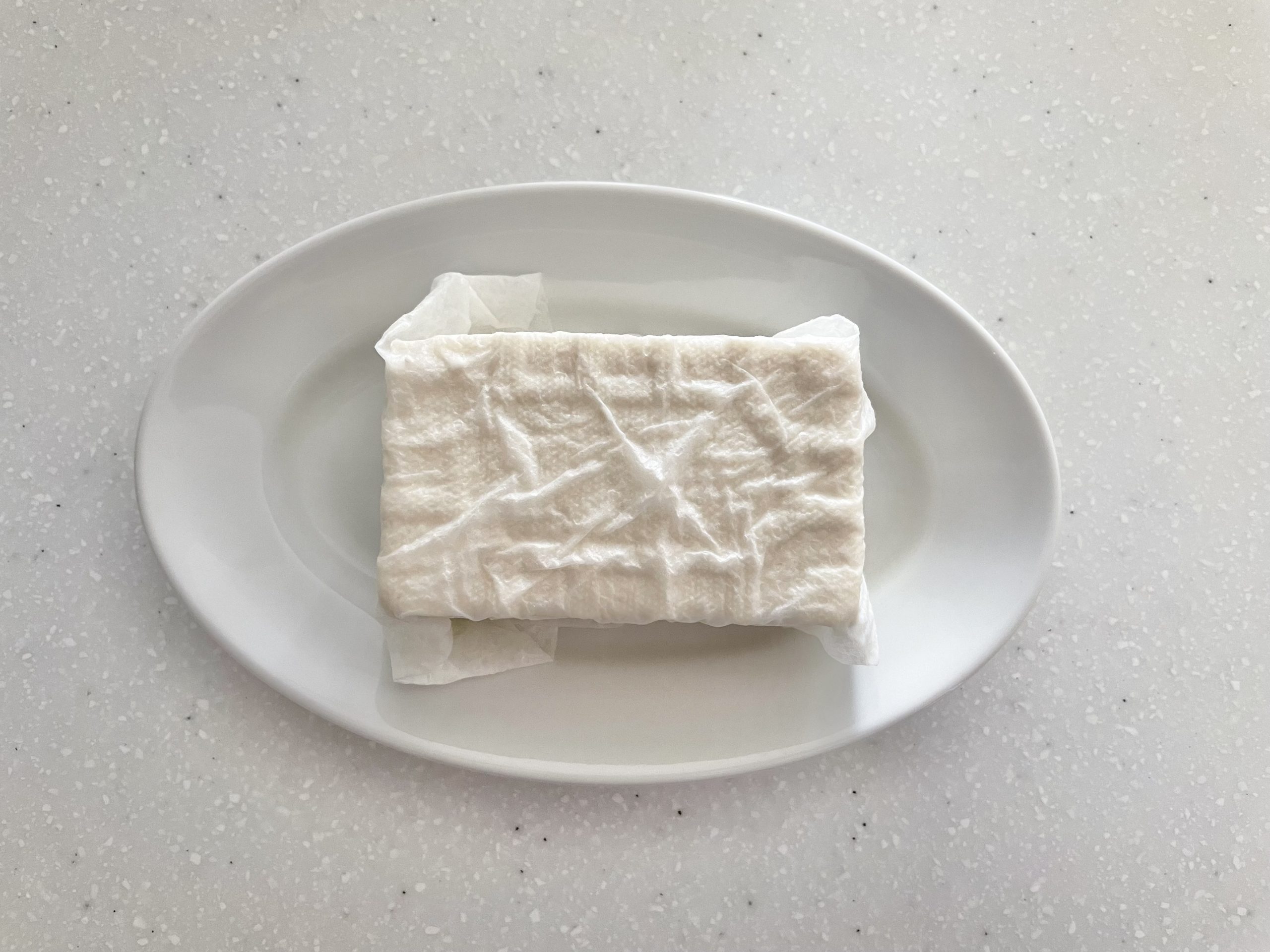 木綿豆腐をキッチンペーパーで包んでおく。